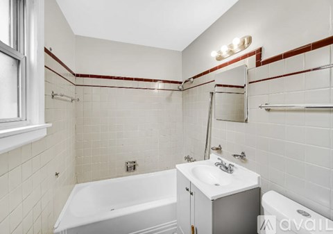 A white bathroom with a white tub and sink.