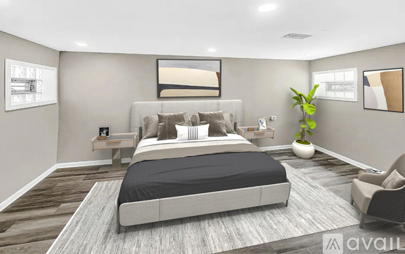 A modern bedroom with a large bed and a chair.