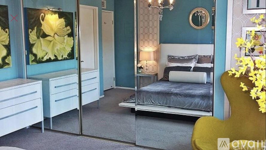 A bedroom with a bed, dresser, and mirror.