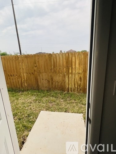 A wooden fence is seen from a window.