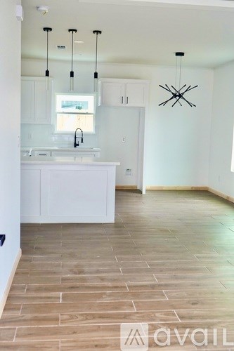 A kitchen with a sink and a window.