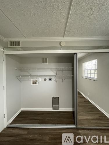 A room with a white ceiling and a window on the right side.