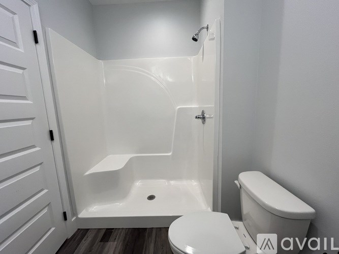 A white bathroom with a toilet, sink, and bathtub.