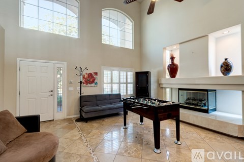A living room with a foosball table in the middle.
