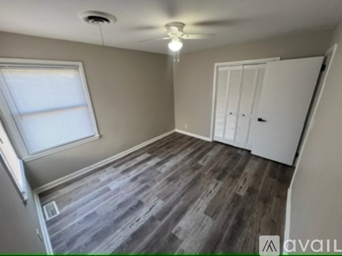 A room with a window and a door is available for rent.