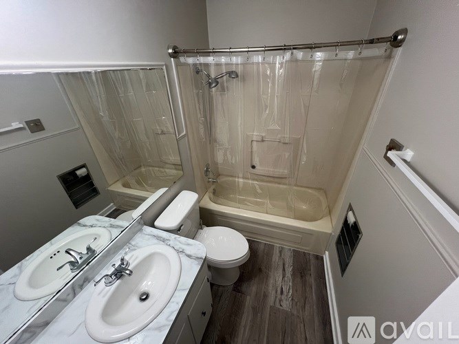 A bathroom with a marble countertop and a walk-in shower.
