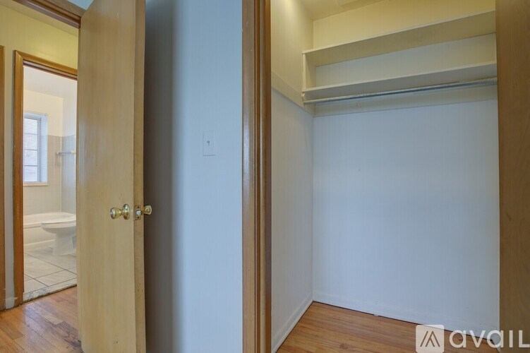 A room with a door and a wall socket.