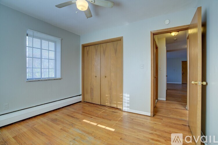 A room with wooden floors and a ceiling fan.