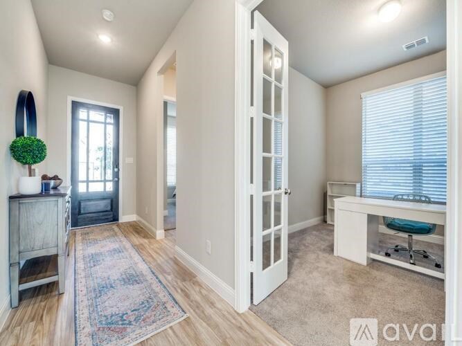 A white closet with clothes and a sign that says "AVAIL".