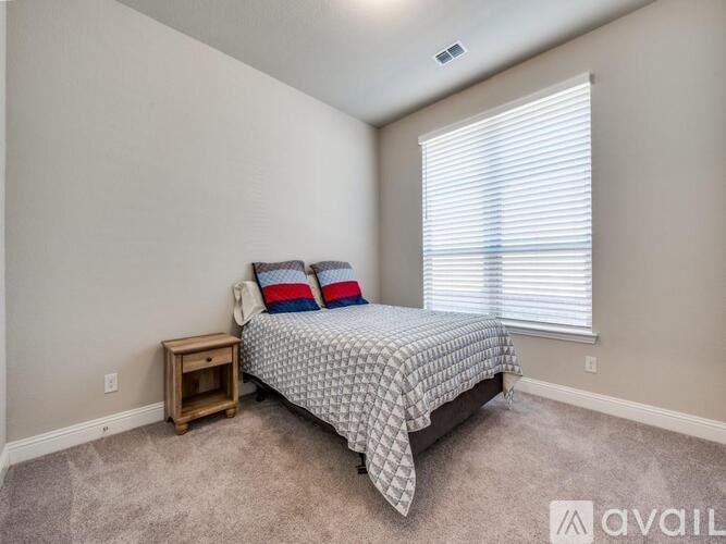 A bathroom with a sink, toilet, and shower curtain.