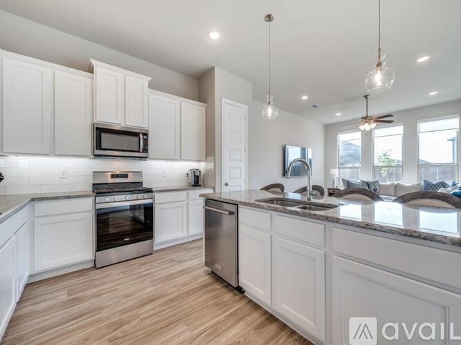 A kitchen with a table and chairs in front of a refrigerator and oven.