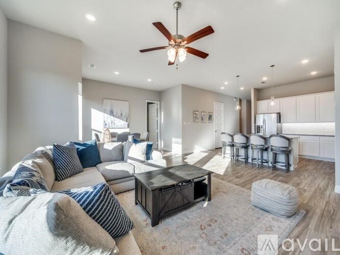 A kitchen with a granite countertop and stainless steel appliances.