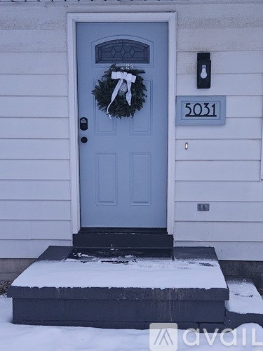 A blue door with a wreath on it.
