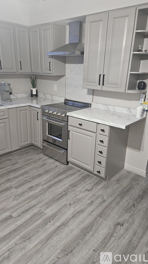 A kitchen with a stove top oven and a counter top.