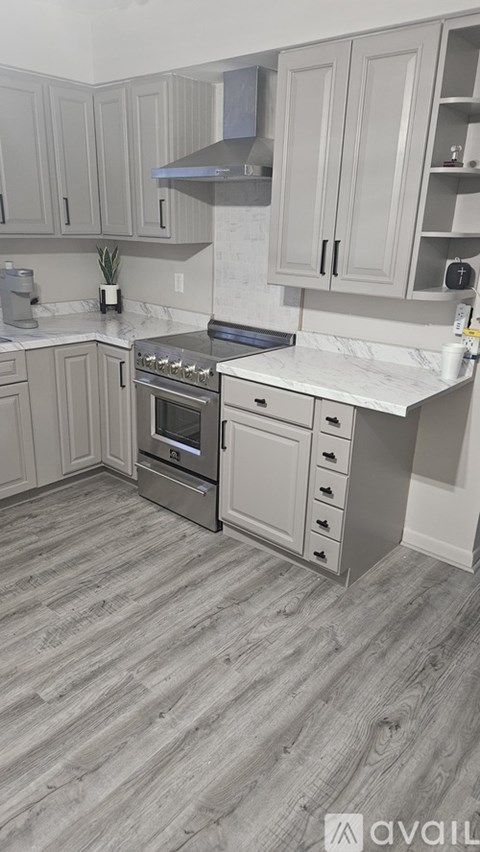 A kitchen with a stove top oven and a counter top.