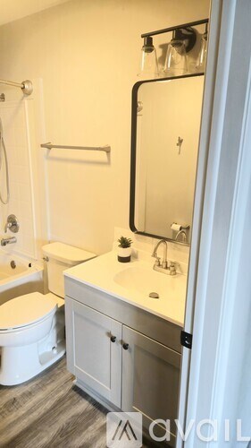 A white toilet is next to a sink in a bathroom.