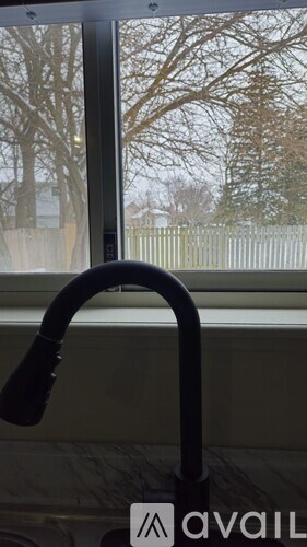 A vacuum cleaner is in front of a window.