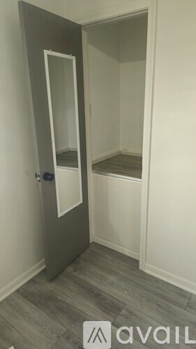 A small, empty room with a doorway leading to another room.