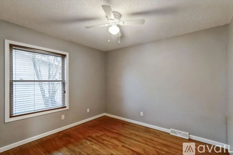 A room with a window and a ceiling fan.