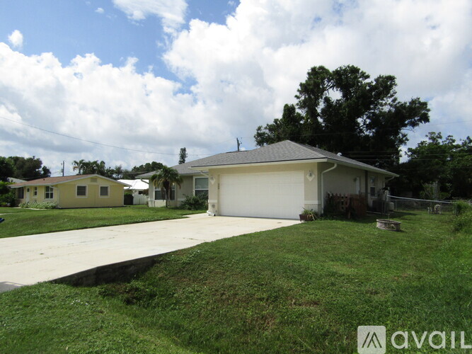 A house with a garage is for sale.