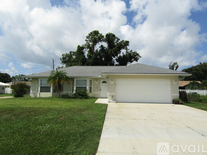 A house with a garage and a driveway is for sale.