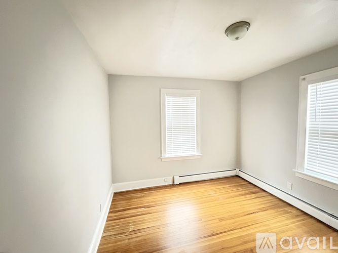 A room with wooden floors and a white door.