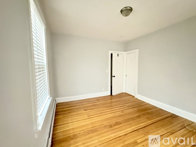 A living room with a couch and a window.