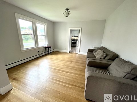 A living room with a couch and a window.