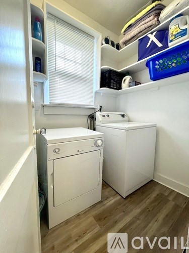 A small laundry room with a washer and dryer.