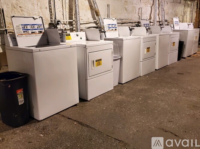 A row of white machines with yellow labels are lined up in a row.