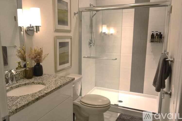 A bathroom with a toilet, sink, and shower.