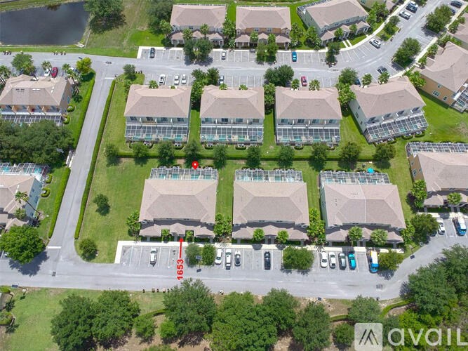 A bird's eye view of a residential area with houses and cars.