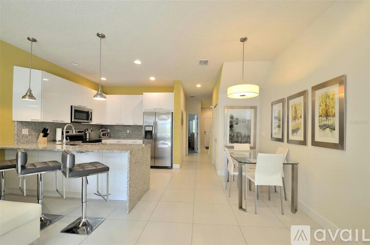 A modern kitchen with a breakfast bar and a dining area.