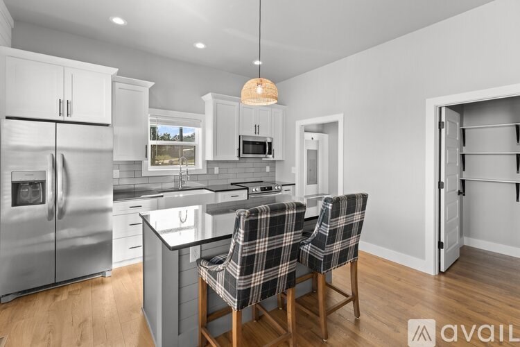 A modern kitchen with a dining table and chairs.