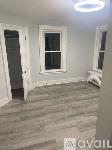 A room with a window and a radiator on the wall.