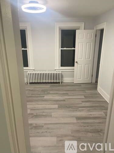 A room with a white door and a window with a white frame.