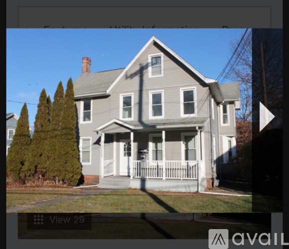 A house with a grey facade and a white porch.