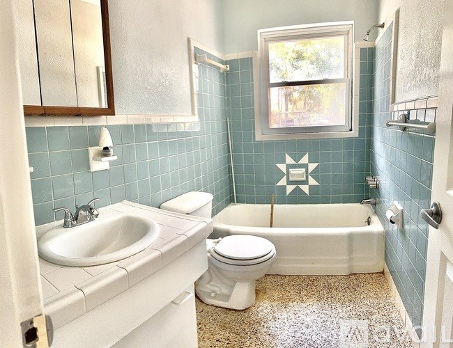 A bathroom with a white toilet and sink.