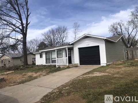 A two-story house with a garage is for sale.
