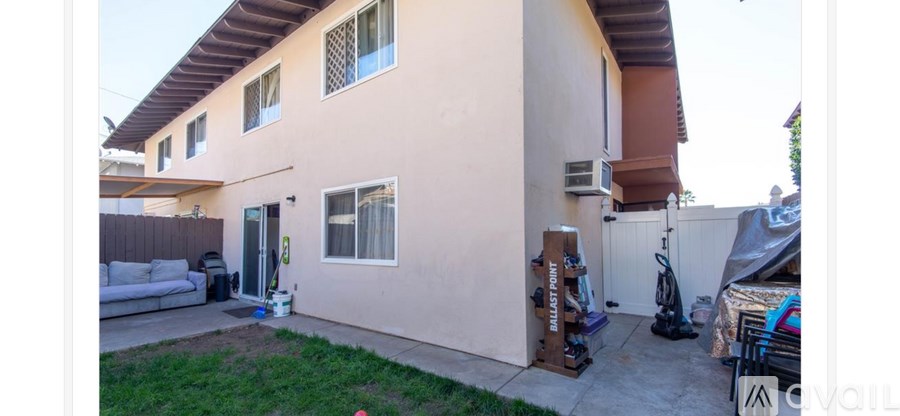 A pink house with a white sofa and a white chair.