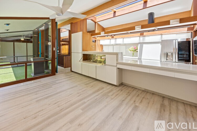 A kitchen with wooden floors and a white counter.