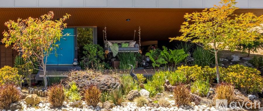 A blue door is on the side of a house.