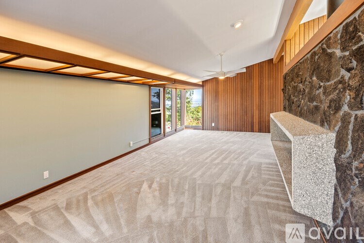 A room with a stone wall and a carpeted floor.