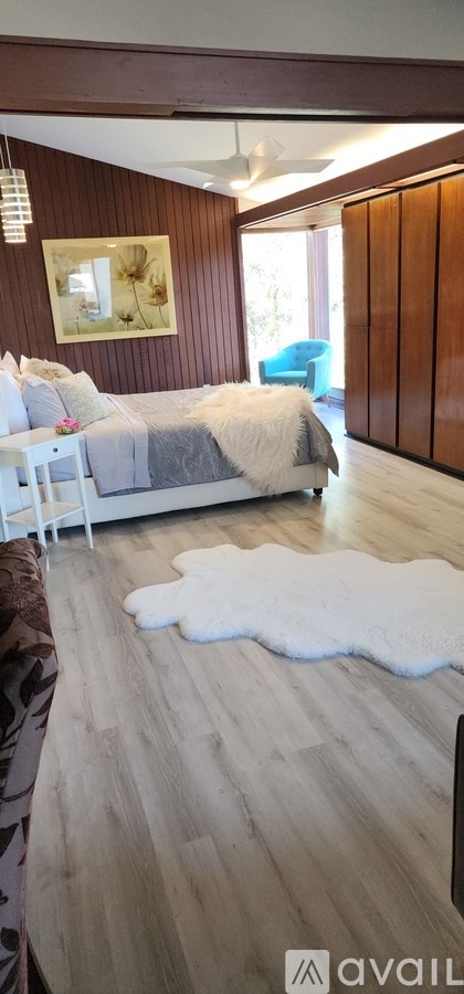 A living room with a couch and a painting on the wall.