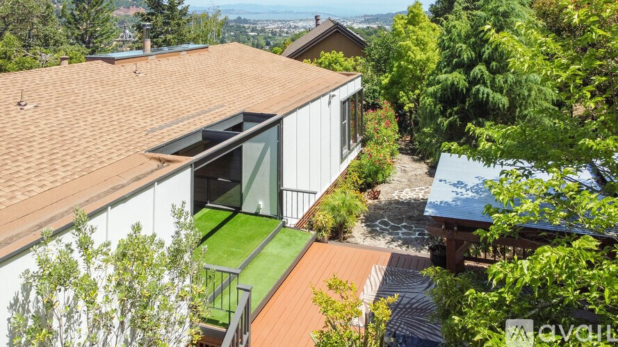 A house with a brown roof and a green lawn.