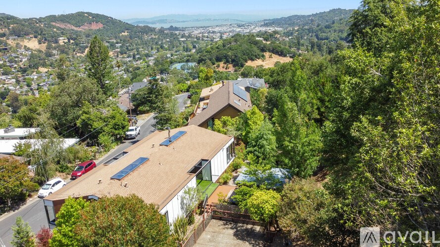A house with a red car parked in front of it.