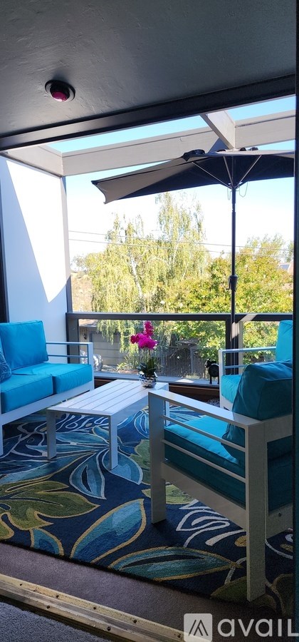 A patio with a white table and blue couches.
