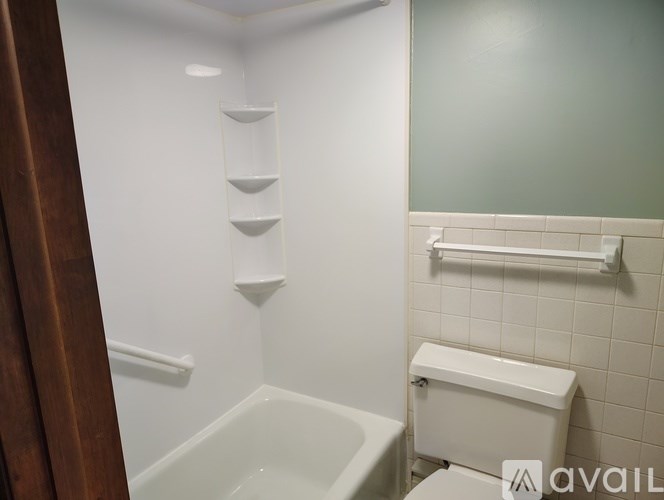 A white bathroom with a toilet, sink, and bathtub.