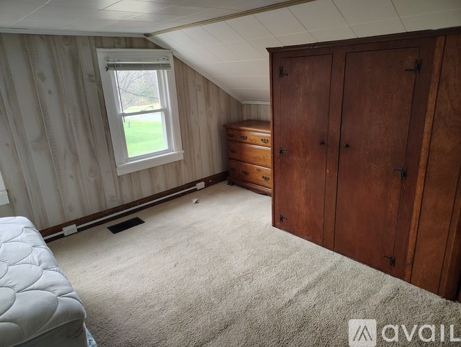 A room with wooden walls and a window.