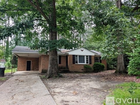 A house with a tree in front of it.